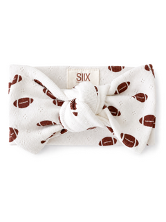 White headband with football pattern and knot detail, labeled with brand SIIX.