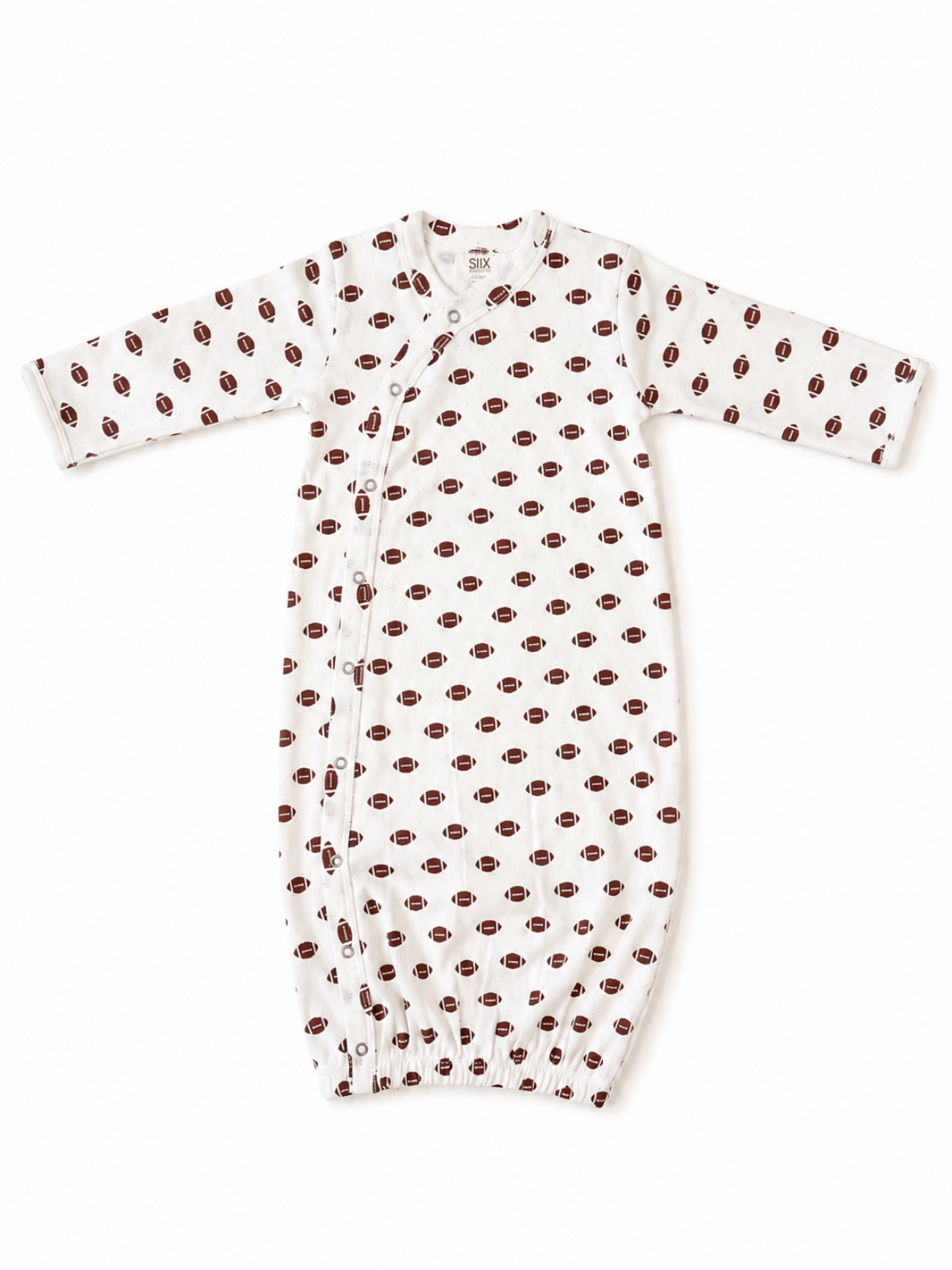 White baby gown with football pattern, featuring long sleeves and snap closures along the side.