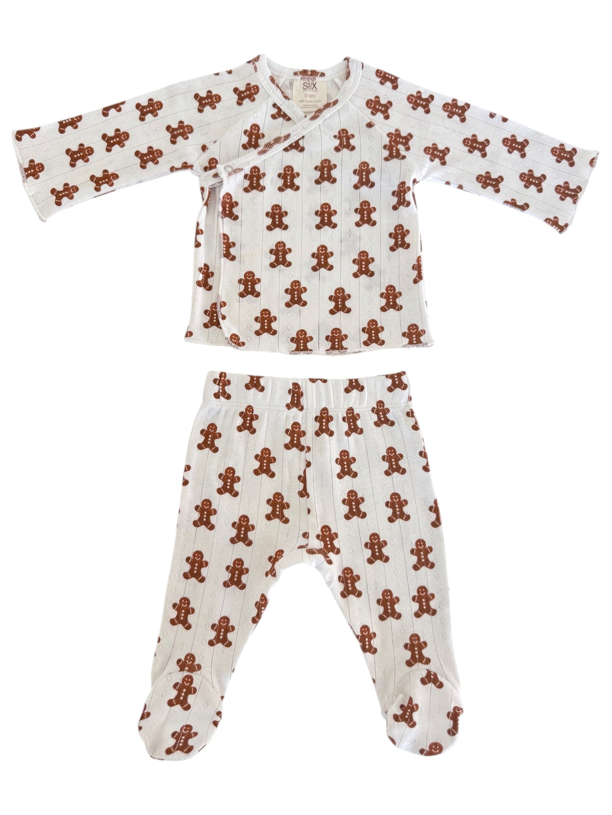 White infant pajamas with a gingerbread man pattern, featuring a top and pants set for cozy wear.