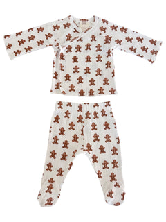 White infant pajamas with a gingerbread man pattern, featuring a top and pants set for cozy wear.
