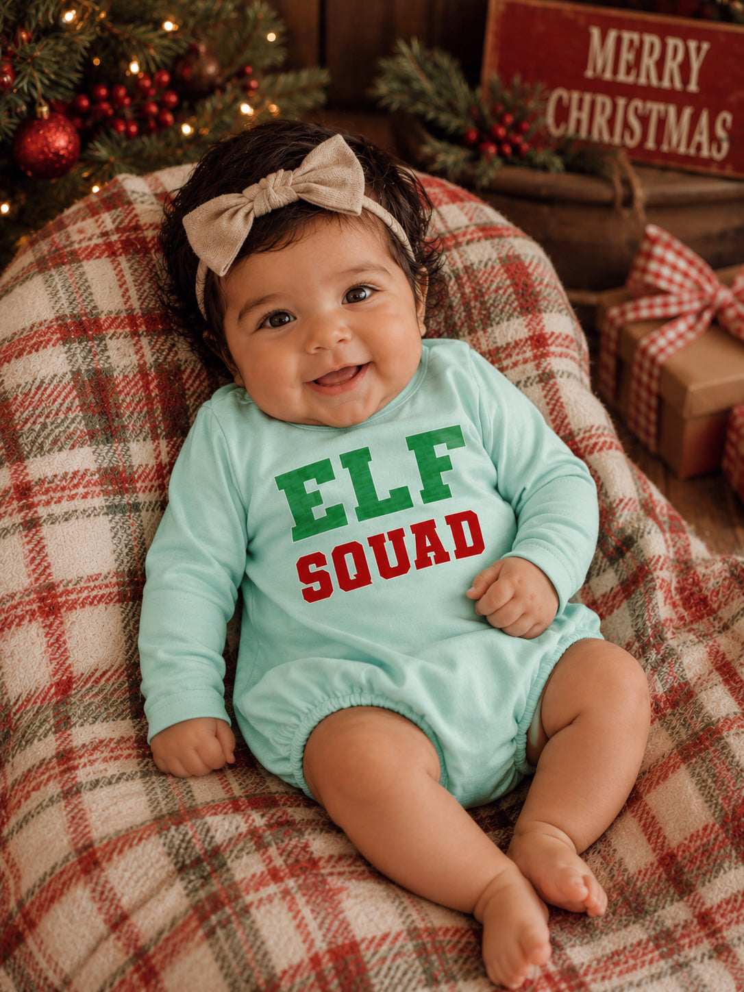 Smiling baby in mint outfit with 