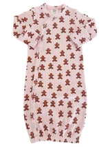 Pink baby gown with brown gingerbread man patterns, featuring snap buttons and long sleeves.