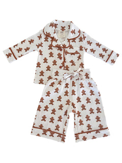 White pajama set with gingerbread man pattern, featuring long sleeves and pants, ideal for cozy nights.
