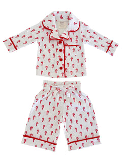 Children's pajamas with red candy cane pattern on white fabric, featuring a collared shirt and matching pants.
