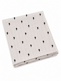 Light gray cloth napkin with black lightning bolt pattern, folded neatly on a white background.