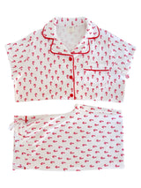 Red and white candy cane patterned pajama set featuring a short-sleeve top and shorts.