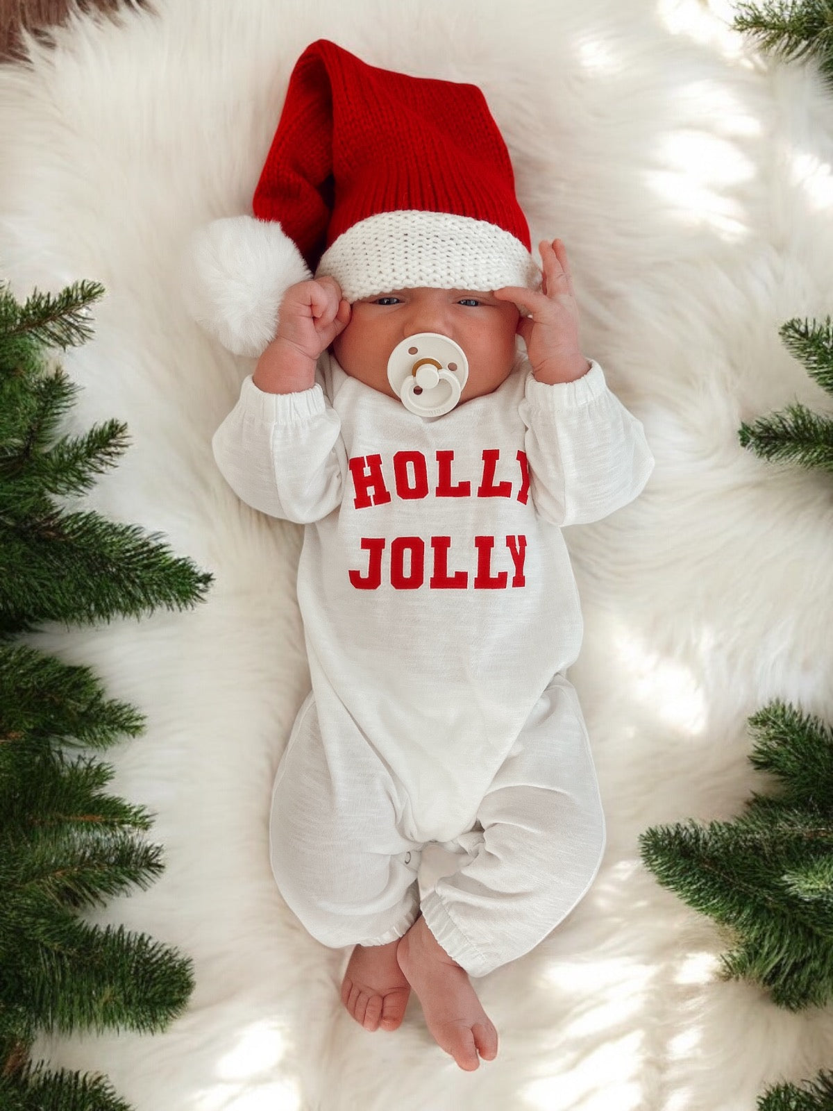 Baby in a red and white outfit with a 
