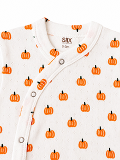 White onesie for infants, featuring a pumpkin print in orange and green, with a snap closure at the neck.