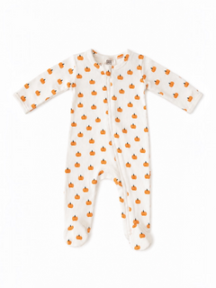 White baby sleeper with orange pumpkin pattern, featuring long sleeves and footed design. Perfect for fall.