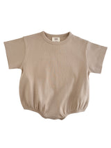 Beige ribbed short-sleeve baby bodysuit with a stretchy waistband. Ideal for comfort and style.