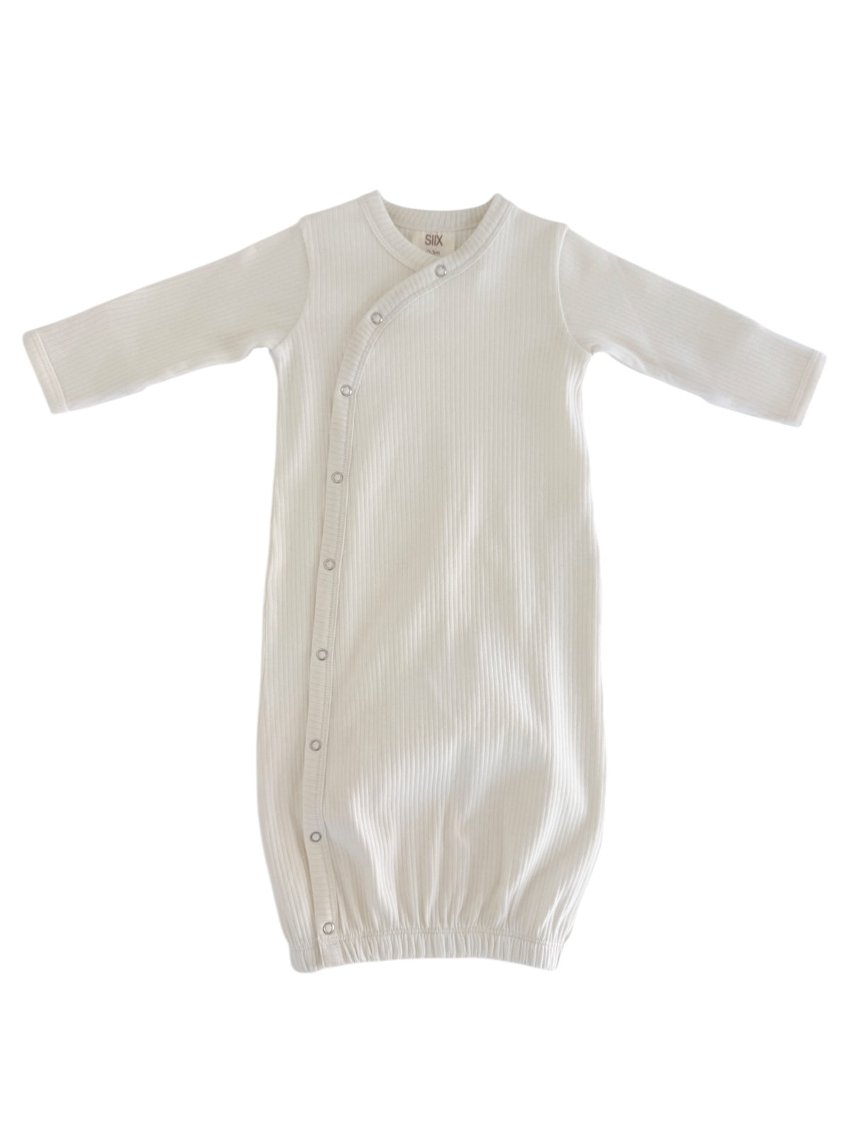 White baby sleep gown with long sleeves and button closure, featuring a ribbed texture and elastic bottom.