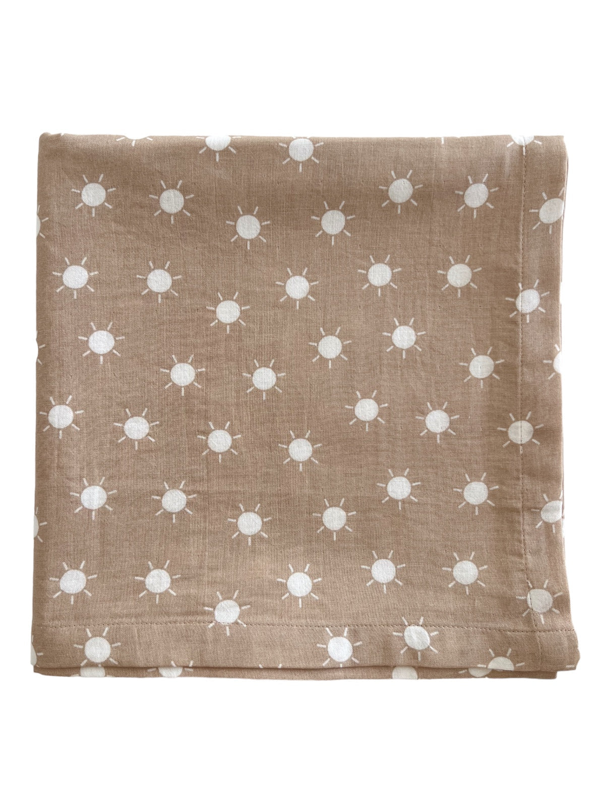 Brown fabric with white sun patterns folded neatly. Ideal for decor or crafting projects.