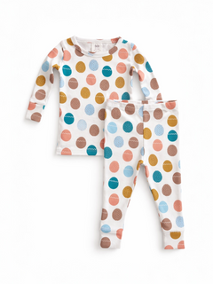 Colorful polka dot toddler pajama set featuring a long-sleeve top and matching pants.