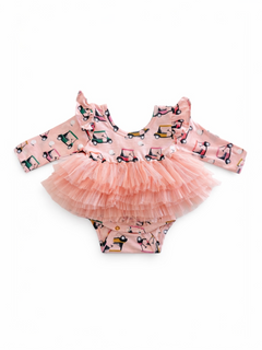 Pink ruffled dress with a frilly skirt and a playful vehicle pattern, perfect for young children.