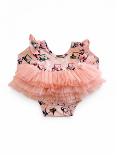 Pink baby swimsuit with ruffled sleeves and layered tulle skirt, featuring colorful golf cart patterns.