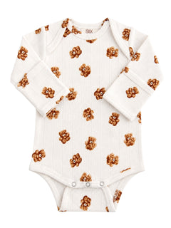 White baby onesie with teddy bear pattern on a textured background. Ideal for infants, cozy and stylish.