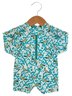 Children's short-sleeve swimsuit with turquoise wave and banana print, displayed on a wooden hanger.