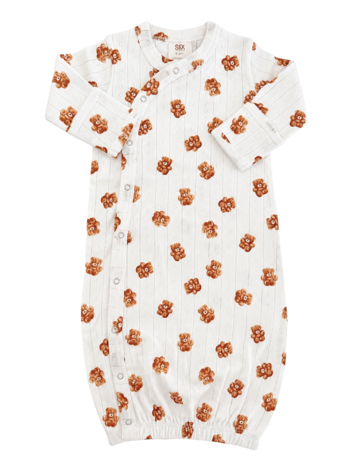 White baby gown with teddy bear print, featuring long sleeves and button closures. Soft and cozy for infants.