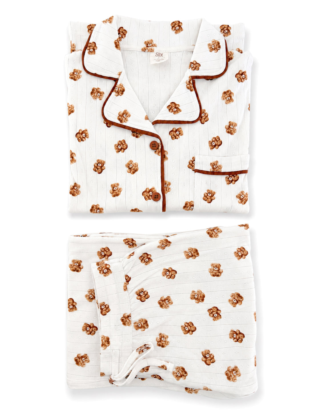 White pajama set featuring brown floral patterns, neatly folded with a top and bottom piece visible.
