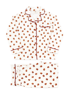 Patterned white pajama set featuring red trim and floral designs, laid flat on a white background.