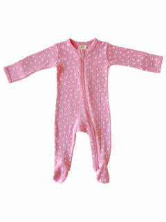 Pink baby onesie with long sleeves and a front zipper, decorated with small white flowers.