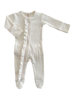 White baby onesie with ribbed texture and ruffle detail, featuring long sleeves and a zip closure.