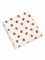 White blanket featuring a repeated floral pattern in shades of brown. Soft and cozy design.