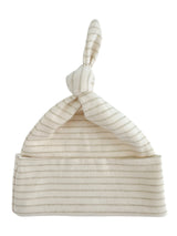 Cream striped baby hat with a knotted top, designed for comfort and style.