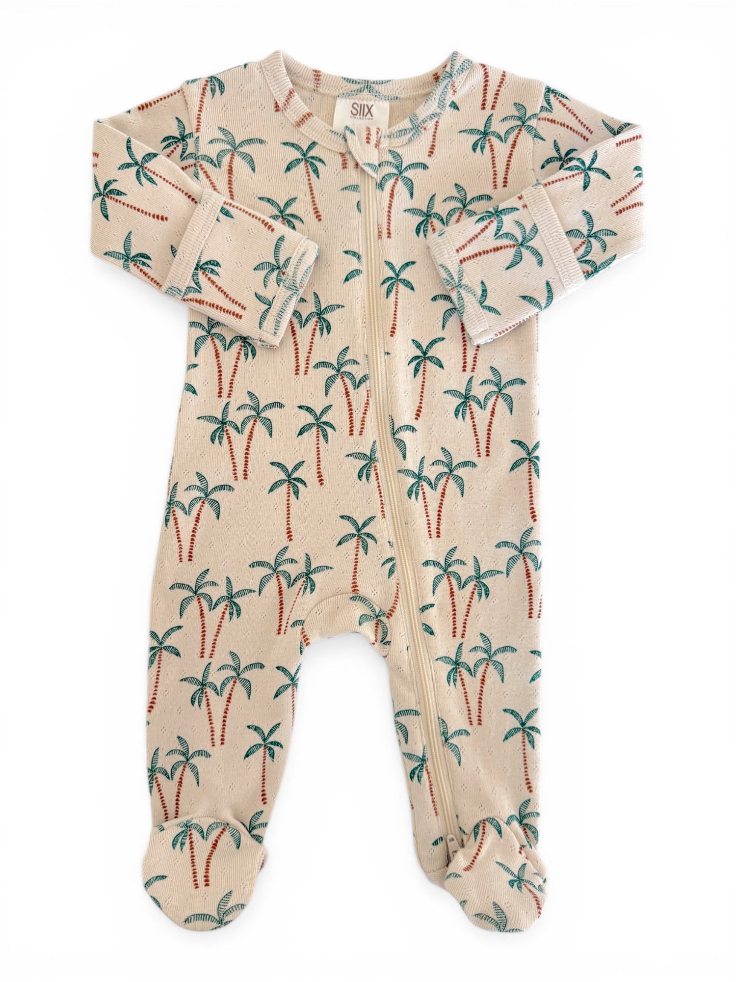 Beige baby onesie with palm tree print, featuring long sleeves and a front zipper. Ideal for warm-weather outings.