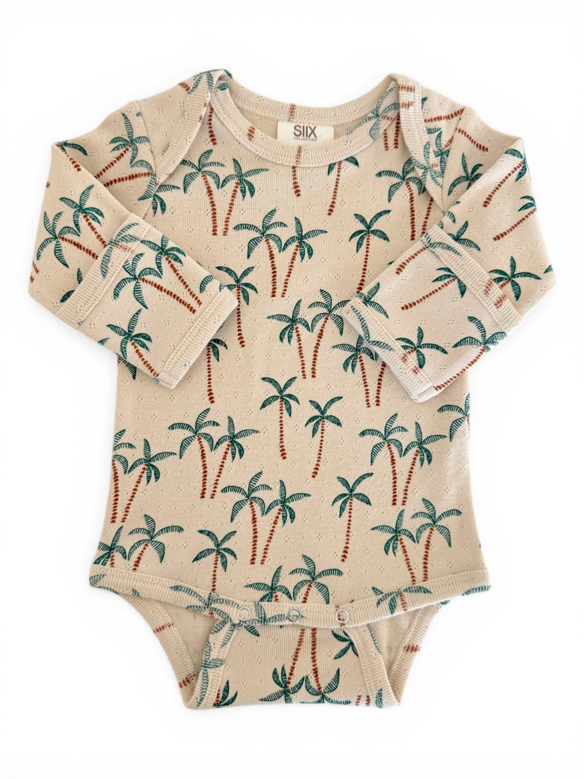 Beige baby bodysuit with palm tree print, featuring long sleeves and snap buttons at the bottom.