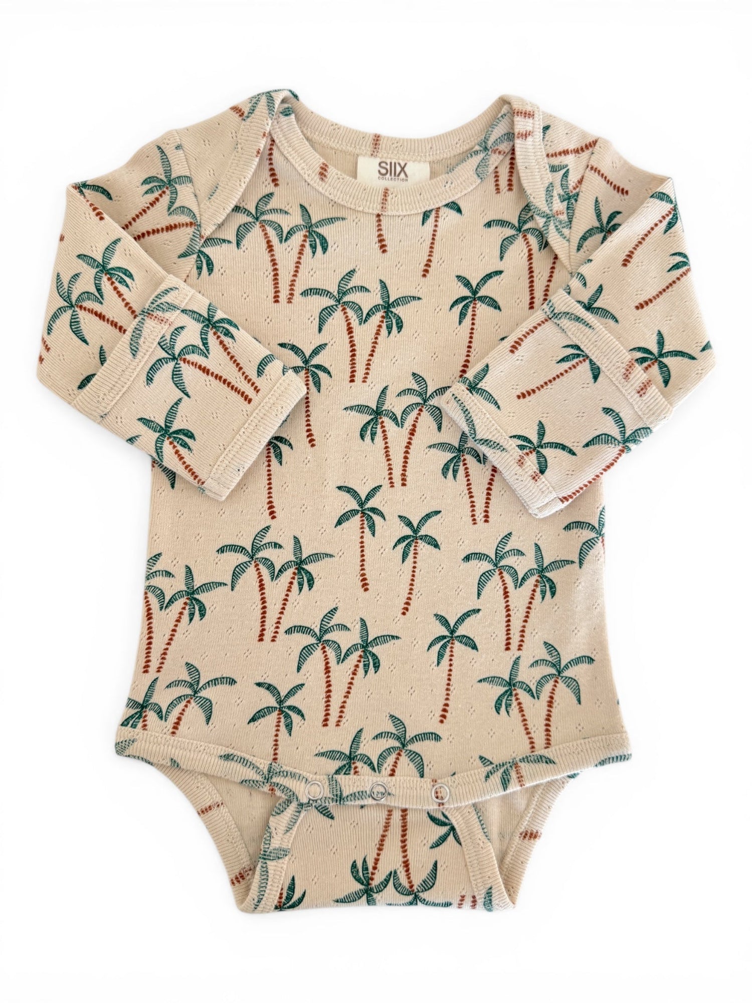 Beige baby bodysuit with palm tree print, featuring long sleeves and snap buttons at the bottom.