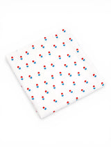 White fabric with a repeating pattern of blue and red ice cream cones.