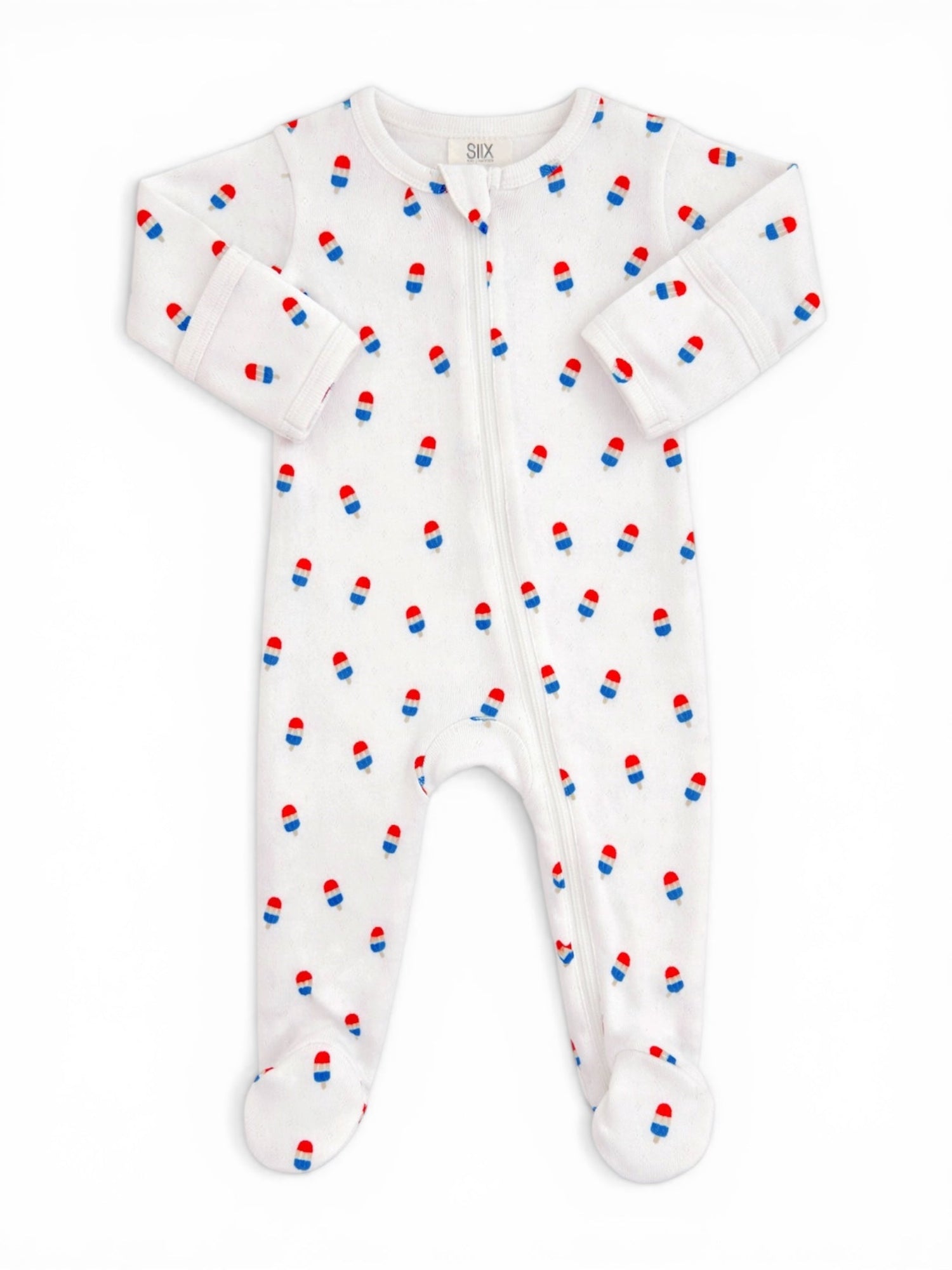 White baby onesie with red and blue pill print, featuring a front zipper and footed design.