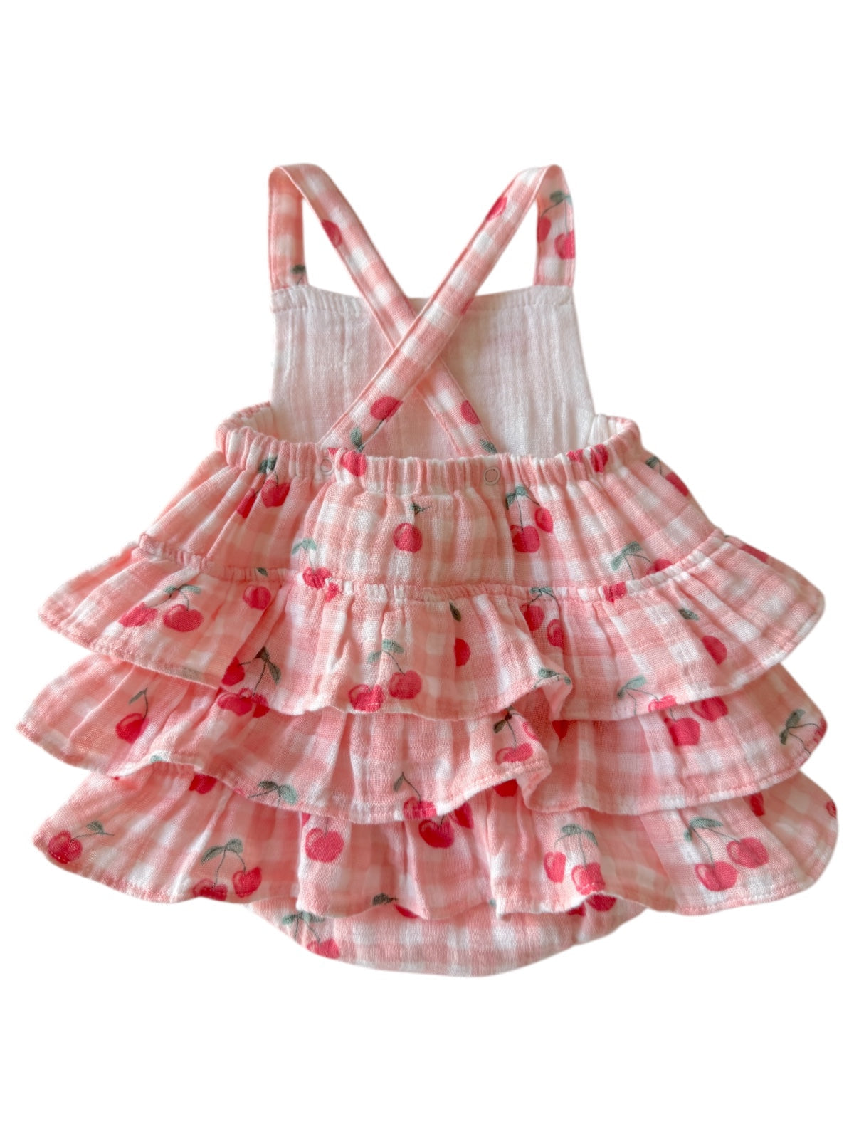 Pink checked dress with cherry patterns and ruffled layers, featuring crisscross straps on the back.