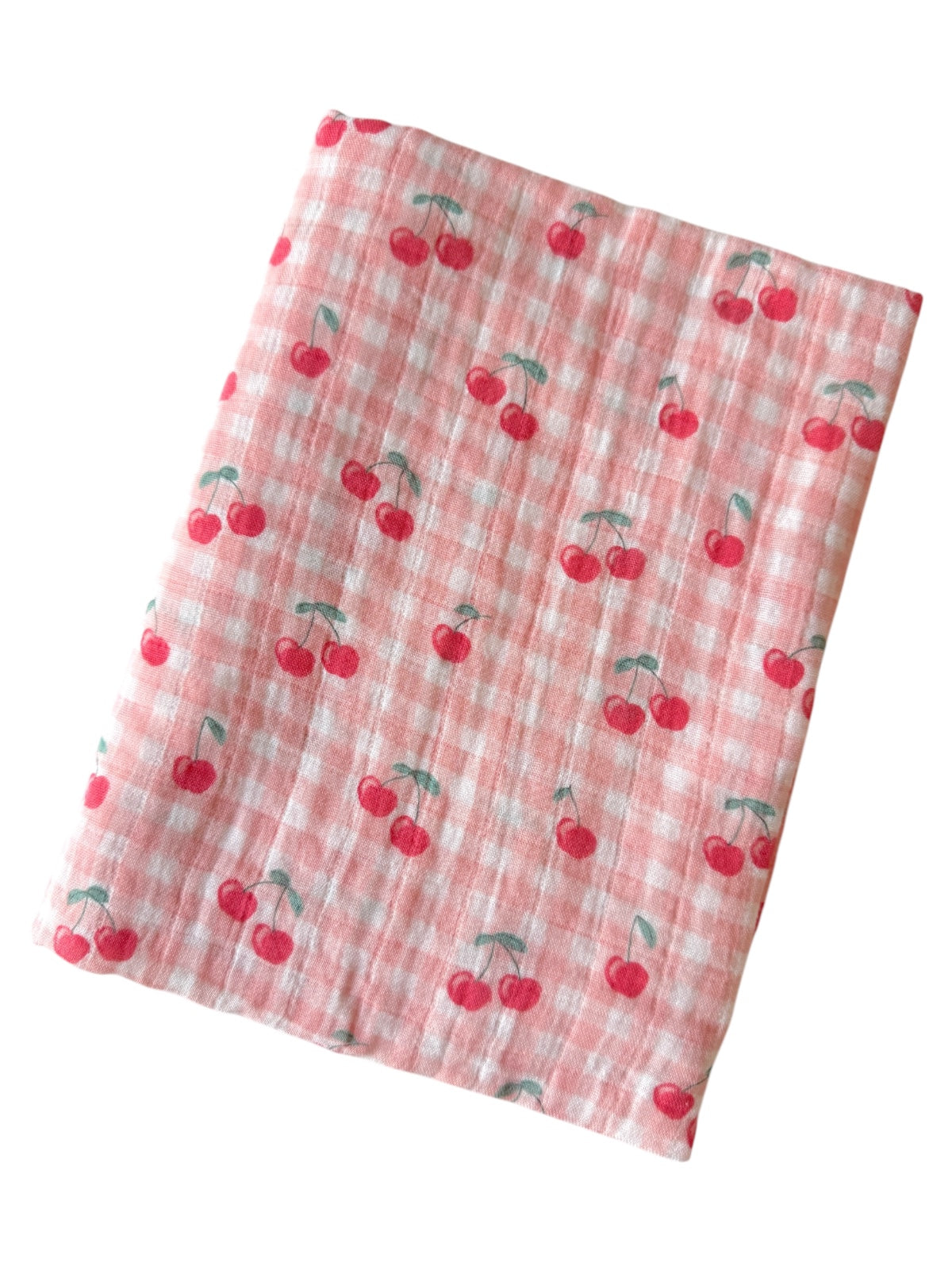 Pink fabric with a checked pattern, featuring a repeated cherry design.