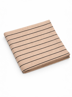 Folded beige fabric with vertical black stripes on a white background.