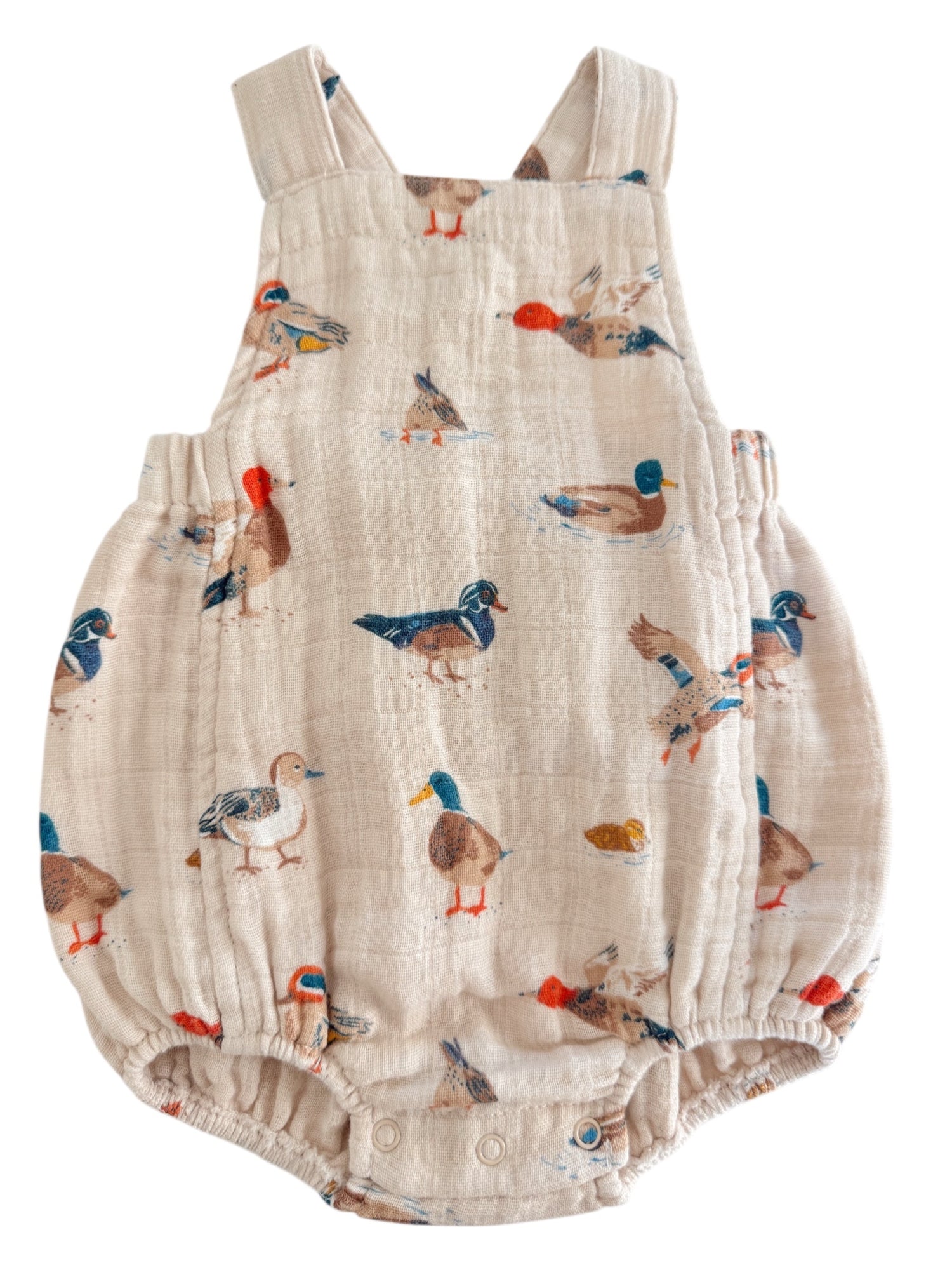 Light-colored baby romper featuring various colorful duck prints throughout the fabric.