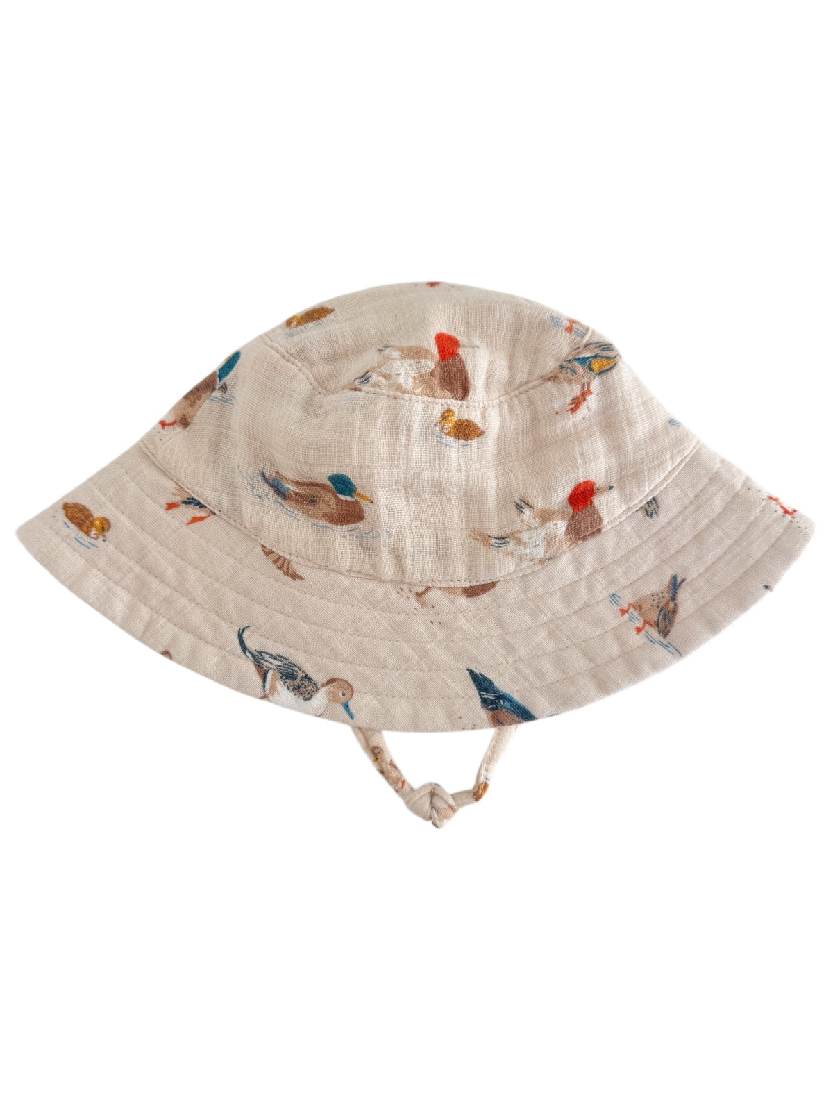 Beige bucket hat with colorful bird prints, featuring a wide brim and chin strap. Ideal for sun protection.