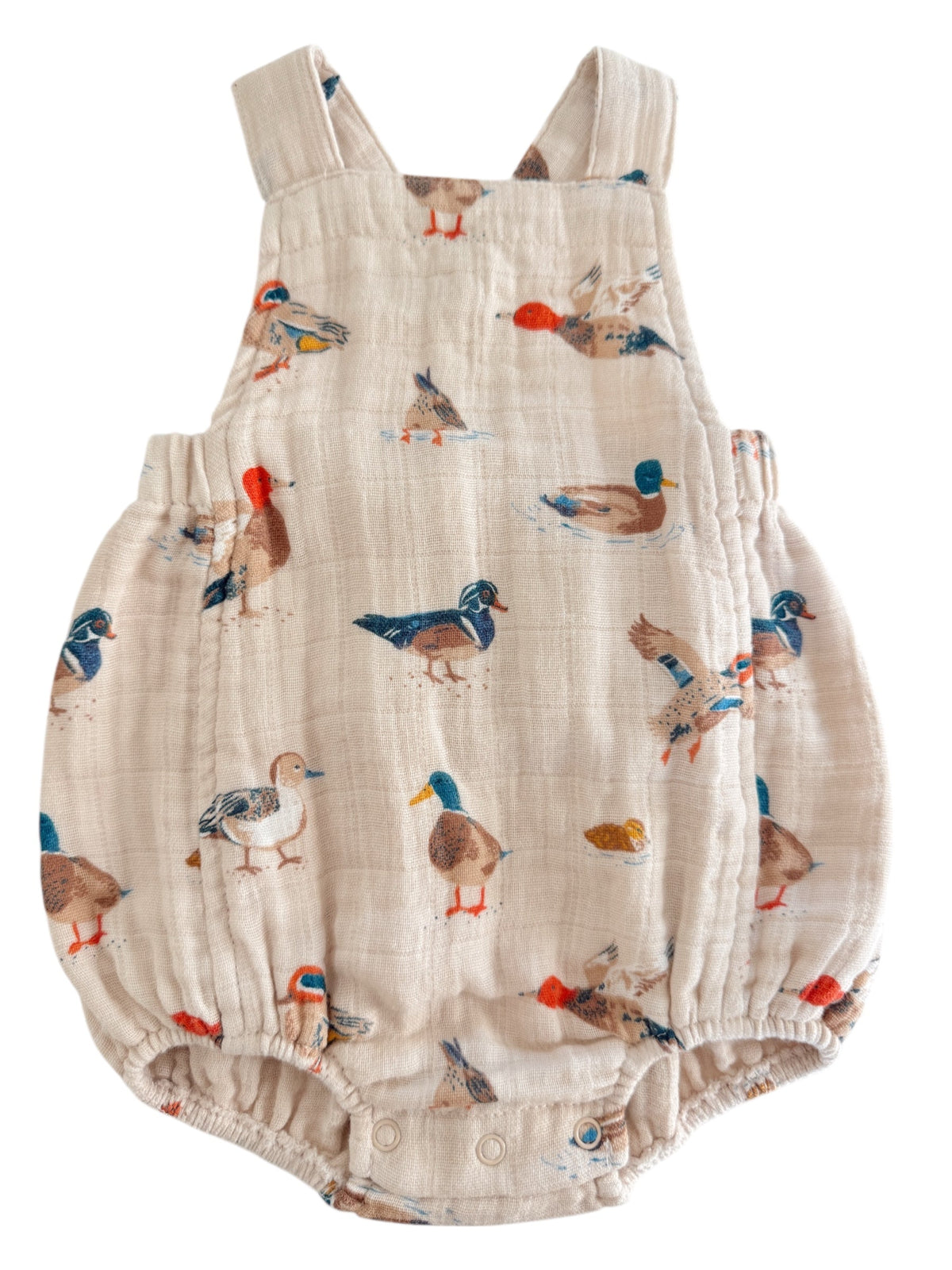 Light-colored baby romper featuring various colorful duck prints throughout the fabric.