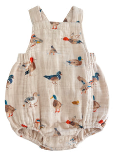 Light-colored baby romper featuring various colorful duck prints throughout the fabric.