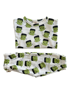 Children's pajama set featuring playful Frankenstein monster print in green and black on a white background.