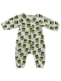 White baby onesie with green Frankenstein faces and black hair, featuring snap buttons down the front and elastic cuffs.