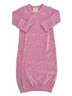 Light pink baby gown with long sleeves and snap buttons, featuring a soft, speckled texture.
