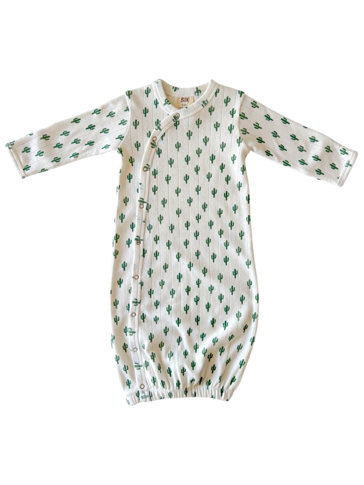 White infant gown with green cactus print and side snap closure. Soft fabric for comfort and easy changes.