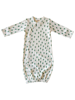 White infant gown with green cactus print and side snap closure. Soft fabric for comfort and easy changes.