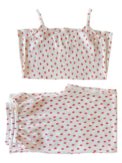 White pajama set with red floral pattern, featuring a cami top and matching drawstring pants.