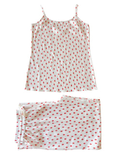 White tank top and matching bottoms with red polka dots, laid flat on a white background.