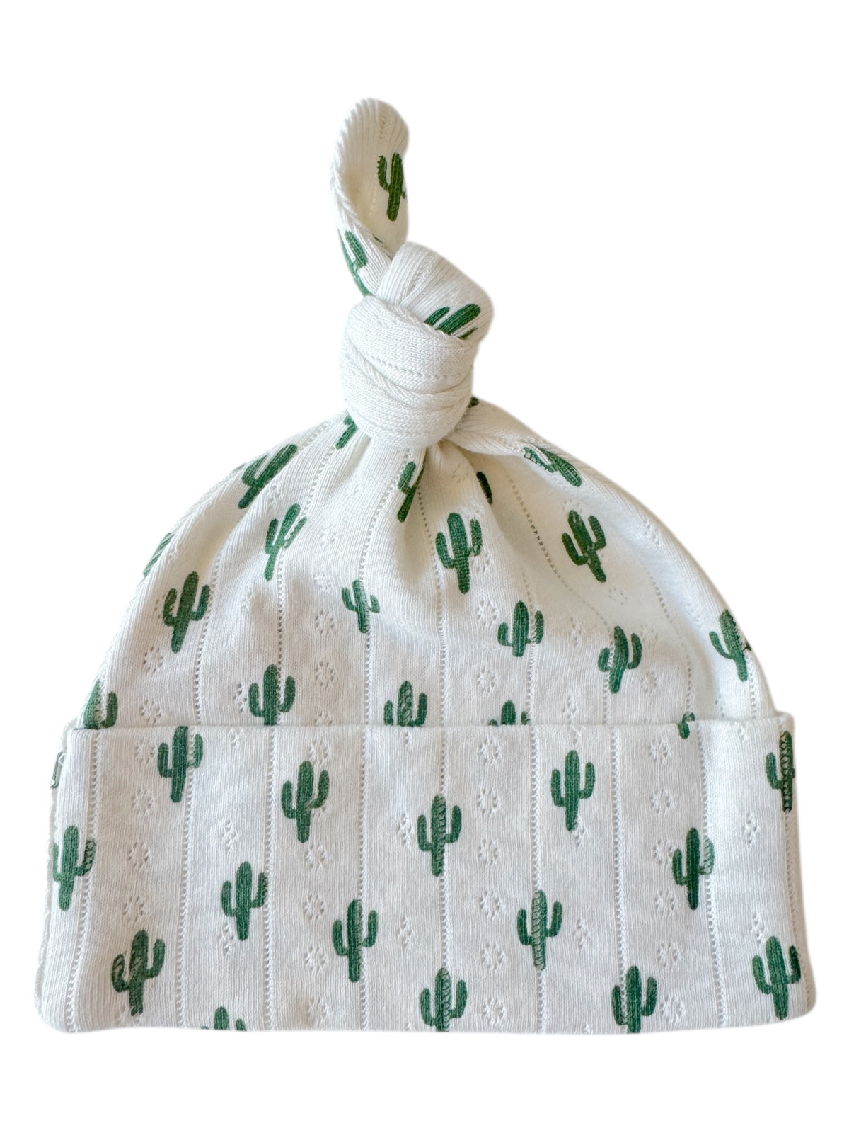 White baby hat with green cactus print and tied top knot design.