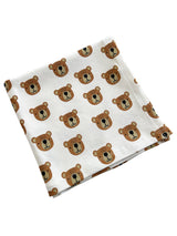 Cotton blanket featuring playful bear face patterns on a white background. Ideal for kids' nurseries or playrooms.