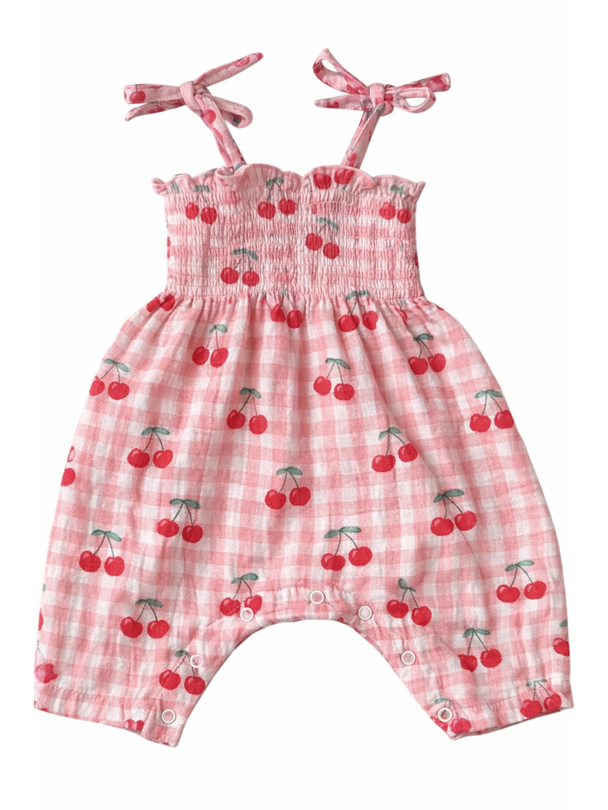 Pink baby romper with cherry print, featuring smocked bodice and shoulder ties. Perfect for warm weather.
